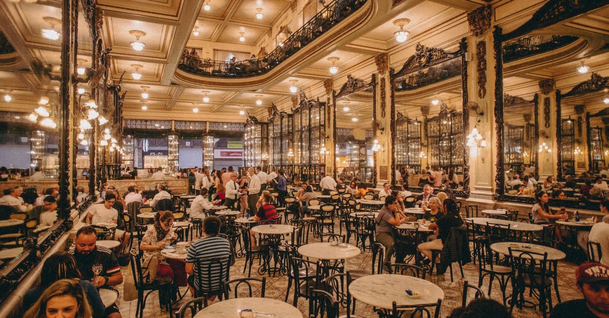 The carved wooden arches, mirrored cabinets and gallery balcony of Confeitaria Colombo in Rio de Janeiro