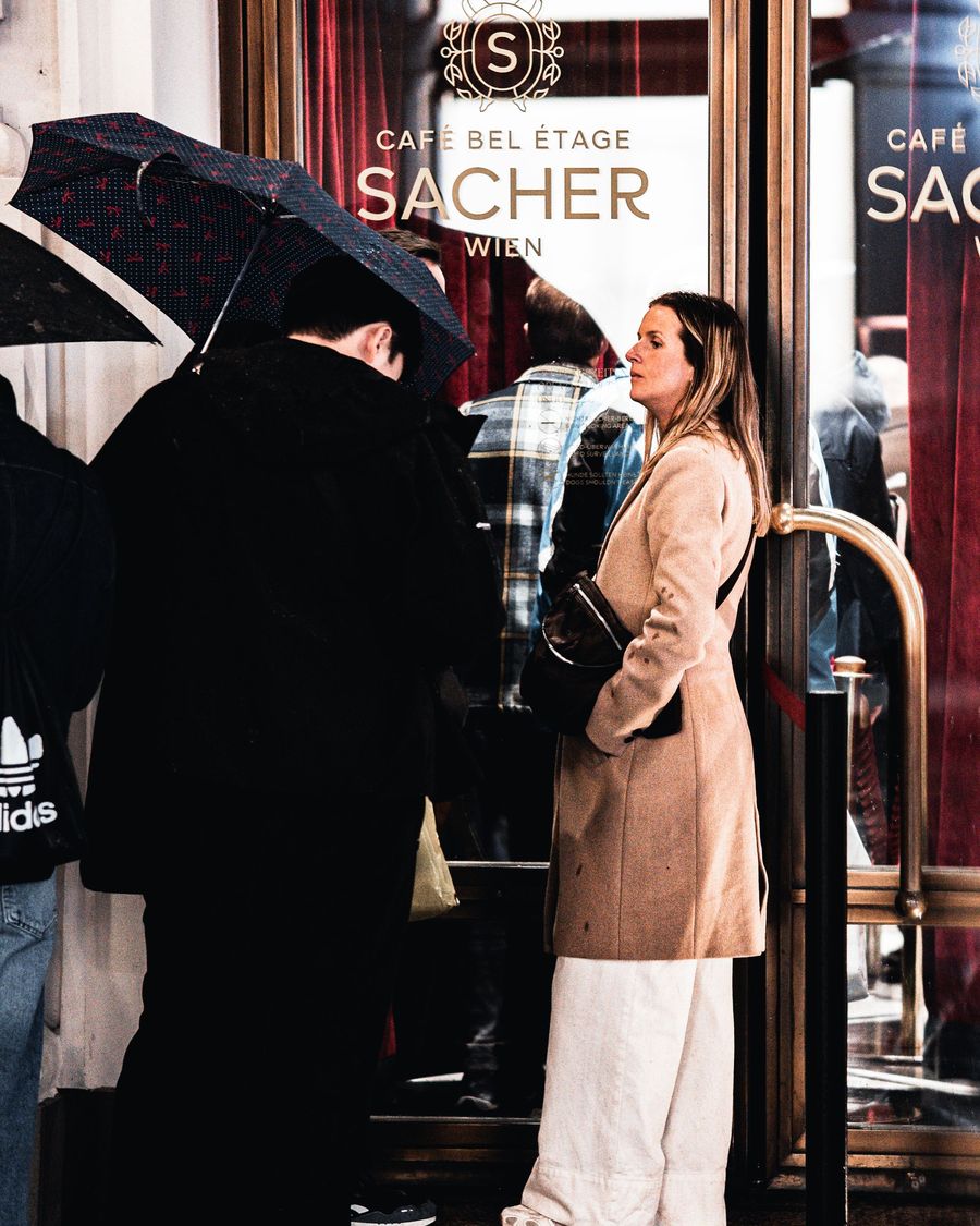 People waiting at the entrance of Café Sacher in Vienna