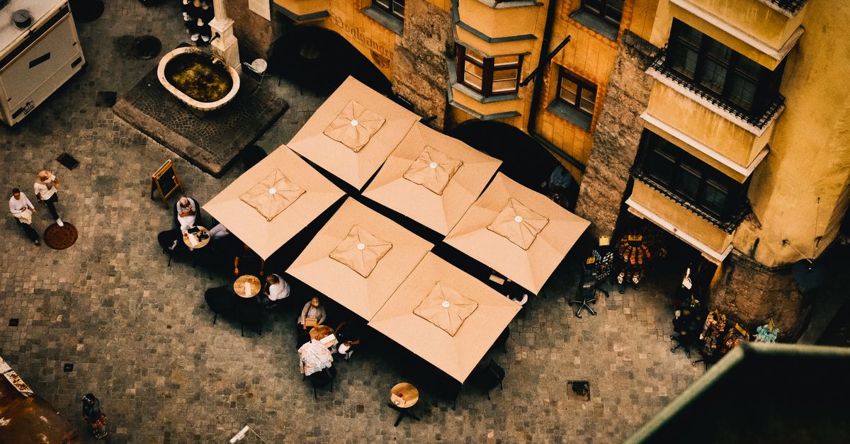 Outdoor café tables on an Australian street in warm sunlight, for a first three months in Perth